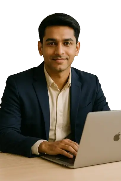 Young Indian male professional sitting confidently at a desk, reading financial course material on a laptop in a well-lit workspace.